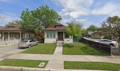 Hanford, CA home bought by Varo as-is: craftsman-style house with a green lawn and a car in the driveway
