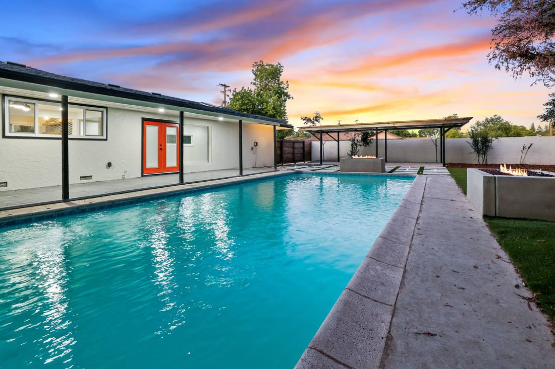 Backyard pool: Pool and patio at dusk